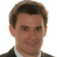 Headshot of a man in a suit.